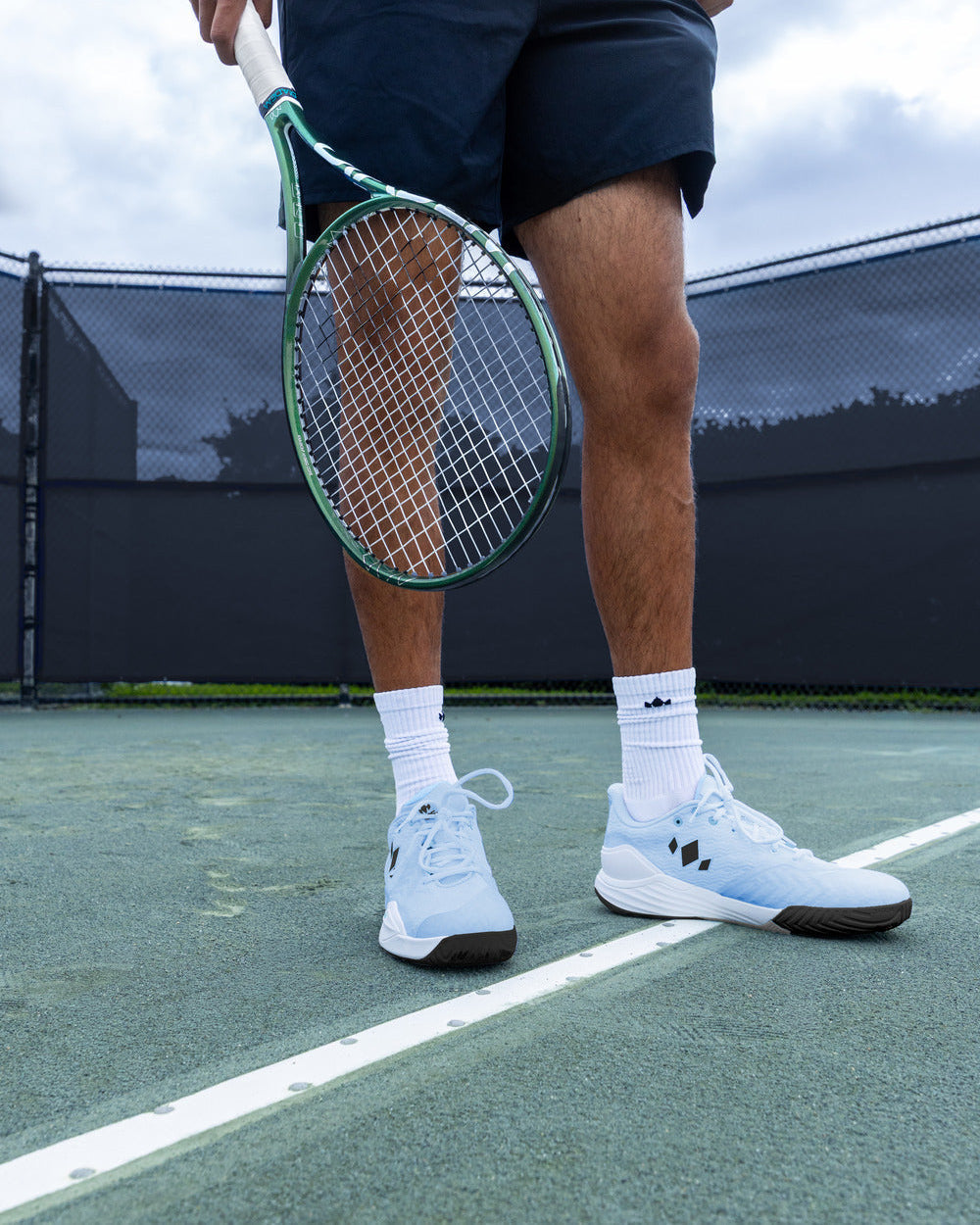Tennis player wearing Diadem Court Burst shoes in Arctic Mist on court