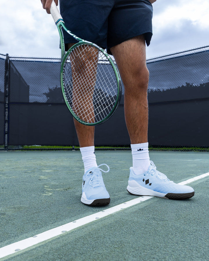 Tennis player wearing Diadem Court Burst shoes in Arctic Mist on court
